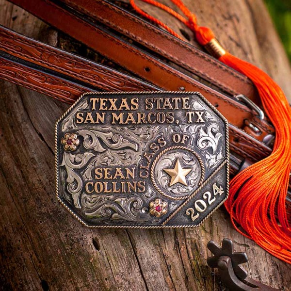 A custom belt buckle for Texas State San Marcos Texas Class of 2024 with personalized name featuring a golden star figure 